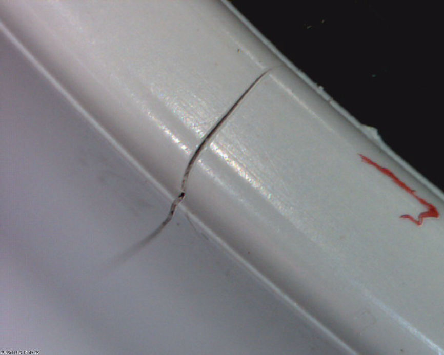 A crack in the molding of a curved piece of casing