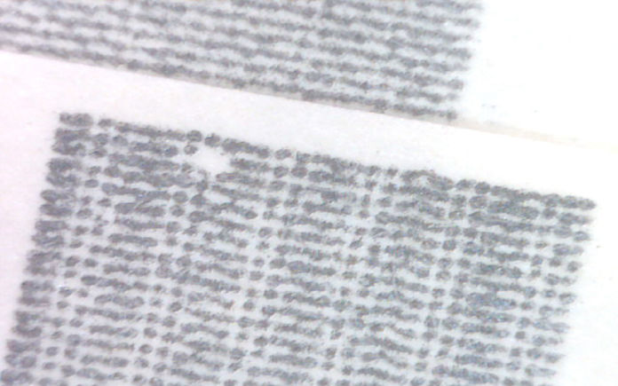 Image of print toner on a page, some of the toner not sticking